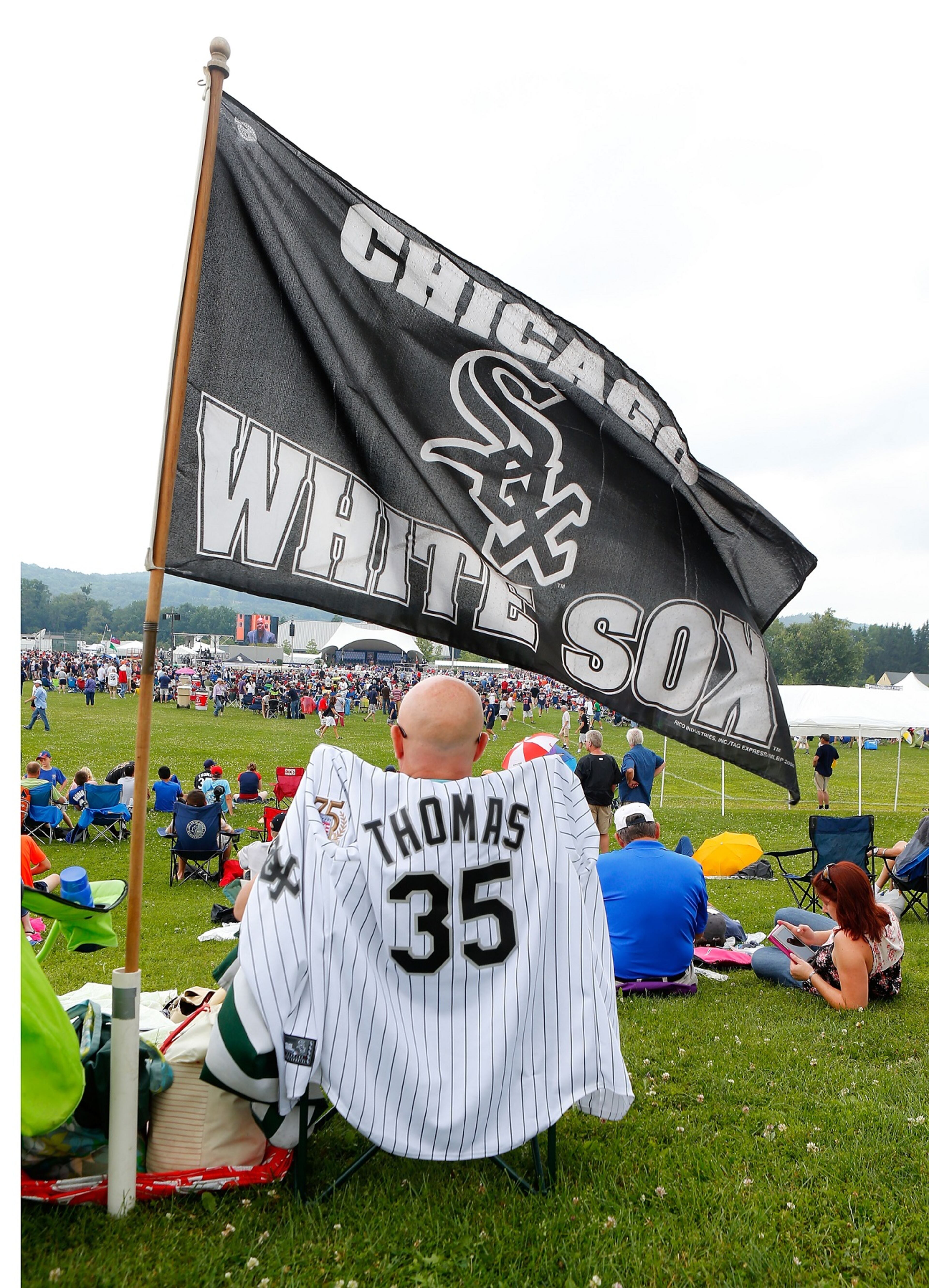 A fan of 2014 inductee Frank Thomas awaits the start of the Baseball Hall of Fame induction ceremony.