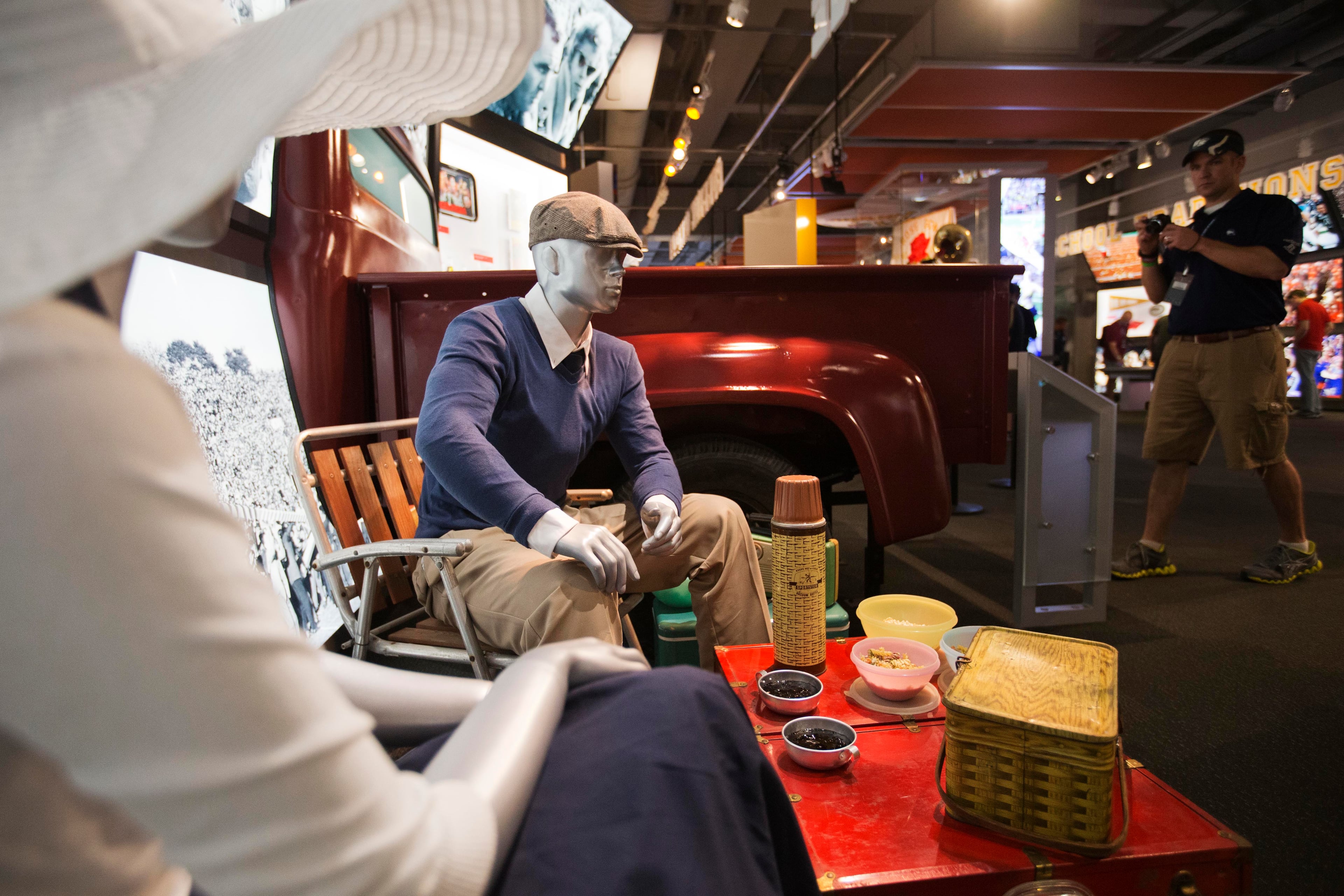 Mannequins portray fans tailgating during the 1950s as part of an exhibit at the College Football Hall of Fame, Wednesday, Aug. 13, 2014, in Atlanta. (AP Photo/David Goldman)