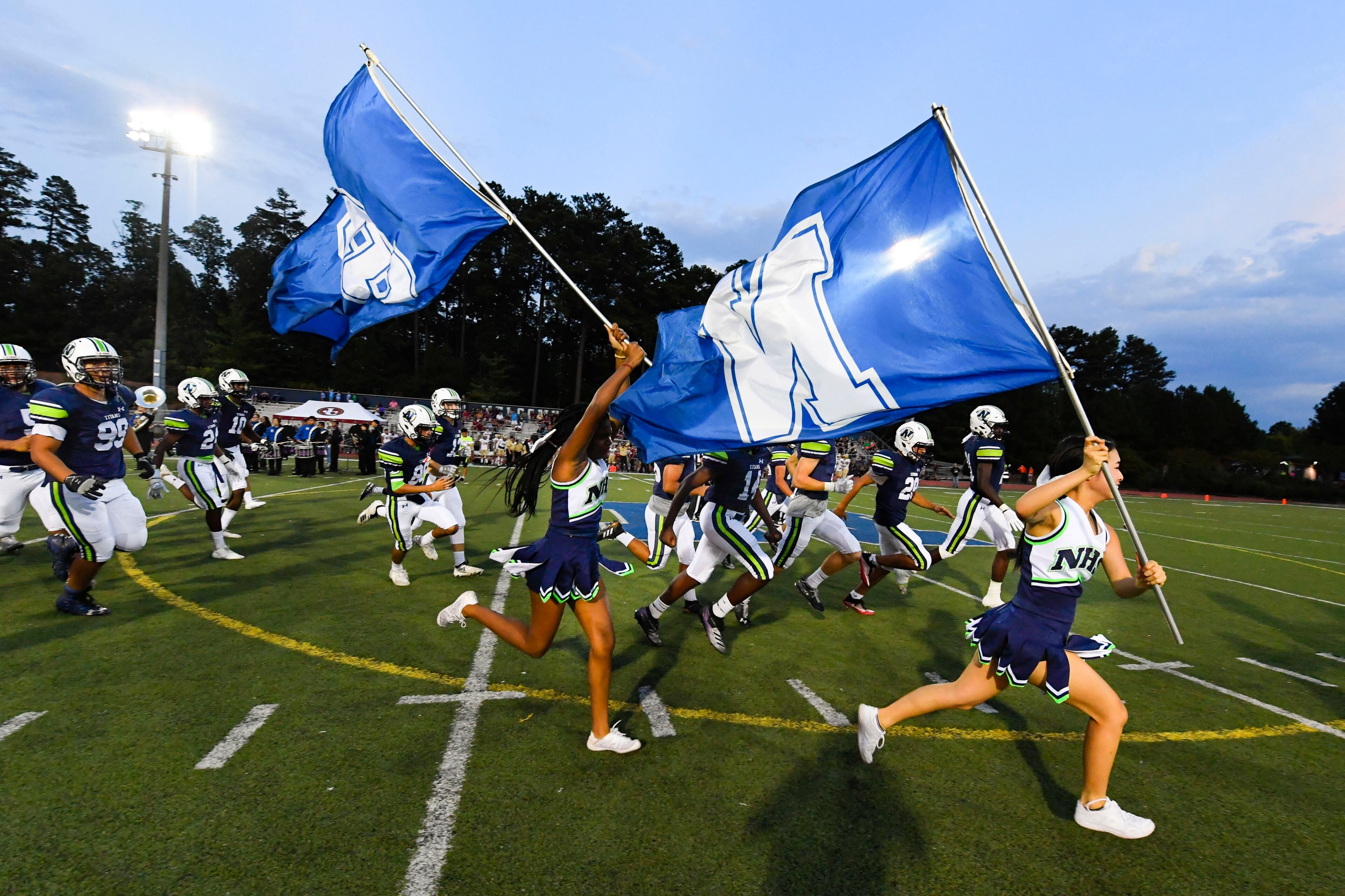 The Northview cheerleaders lead the team onto the field prior to Friday's game at Johns Creek. (John Amis/Special)