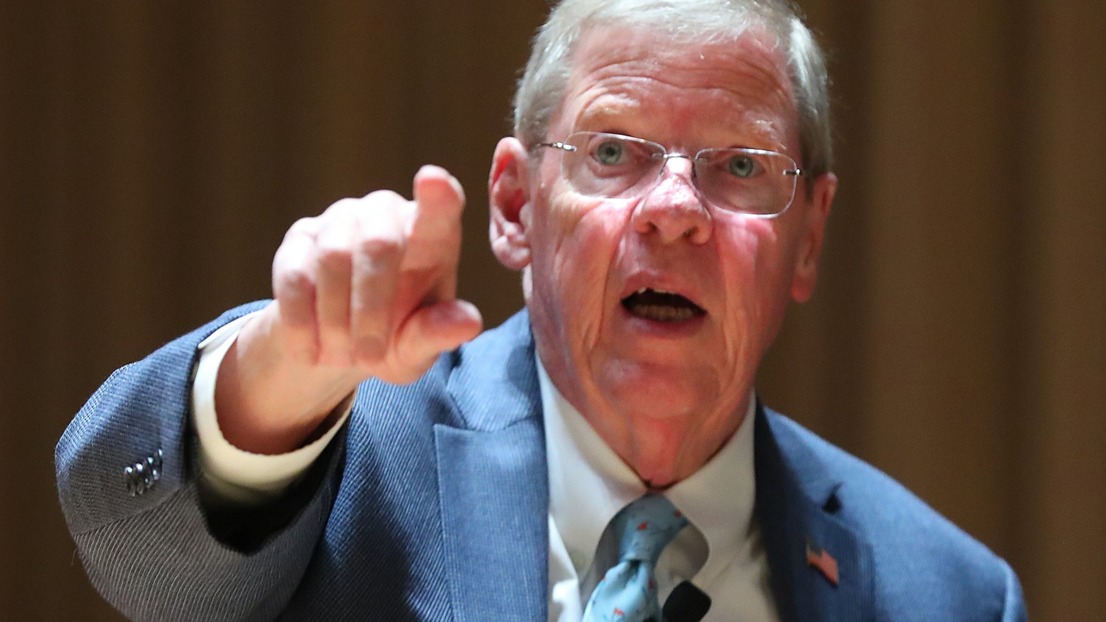 Georgia Republican U.S. Sen. Johnny Isakson points to someone he knows in the crowd as he prepares to hold his town hall meeting Monday at Kennesaw State University. Curtis Compton/ccompton@ajc.com