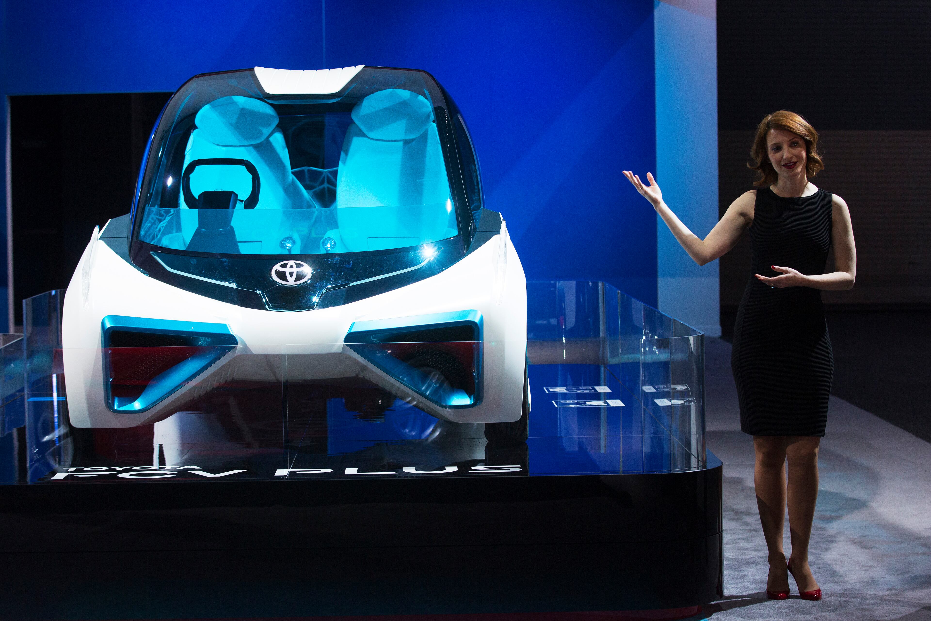 DETROIT, MI - JANUARY 12: A Toyota hostess shows off the Toyota FCV Plus at the North American International Auto Show in Detroit, Michigan. Toronto Star/Todd Korol (Todd Korol/Toronto Star via Getty Images)