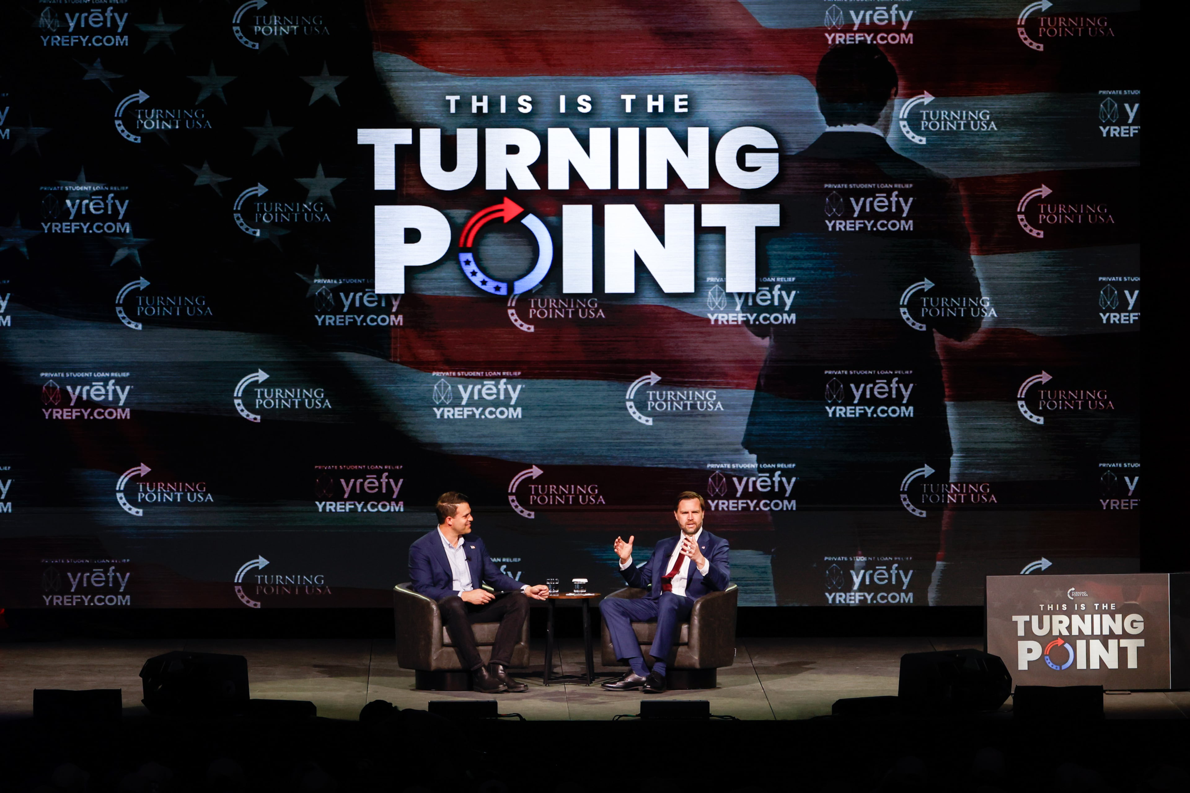 Vice President JD Vance, alongside Turning Point USA spokesperson Andrew Kolvet (left), speaks during a Turning Point USA event at Akins Ford Arena in Athens, Ga., on April 14, 2026. (Arvin Temkar/AJC)