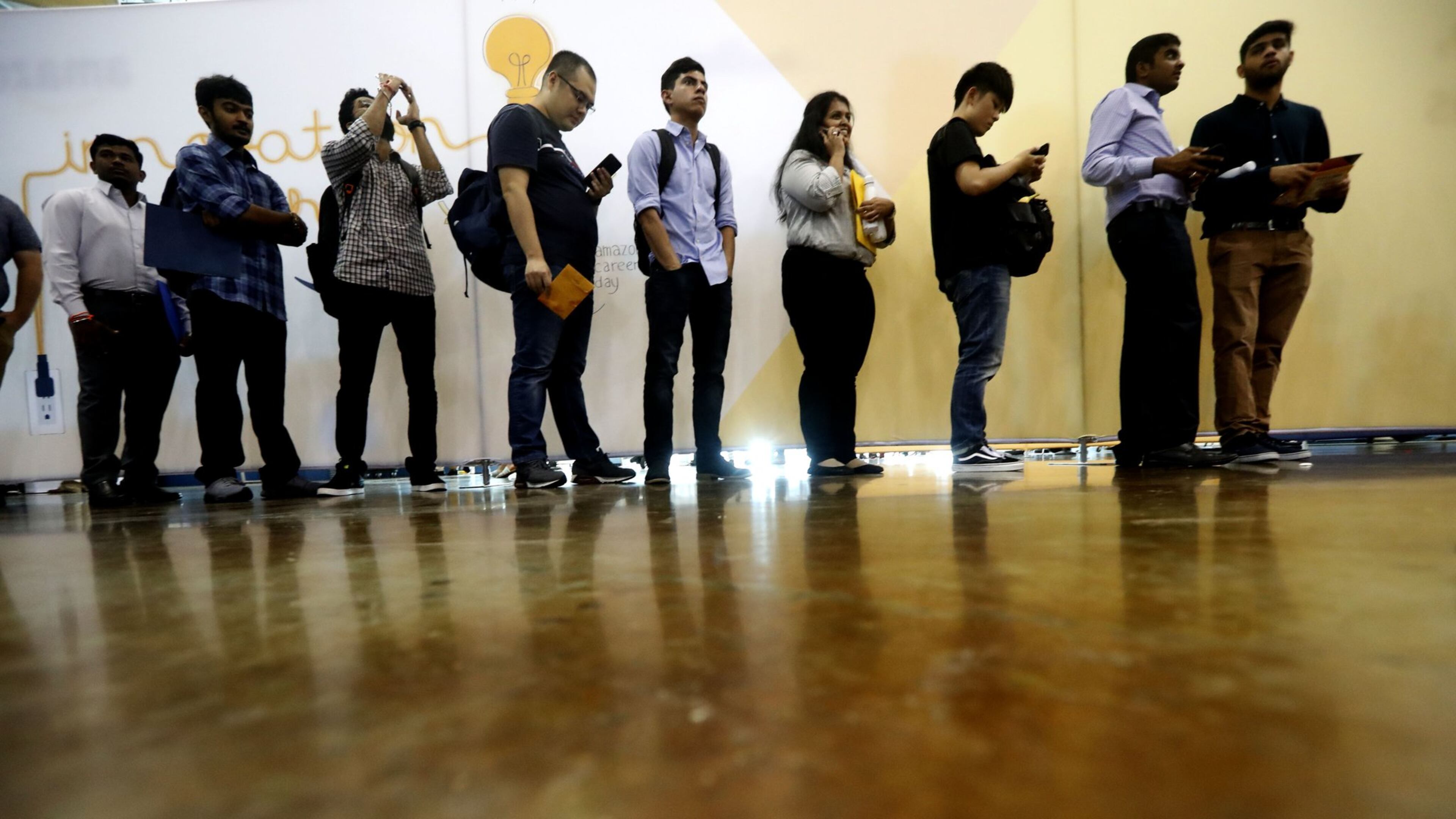Job seekers line up to speak to recruiters during a job fair this fall. (AP Photo/LM Otero)